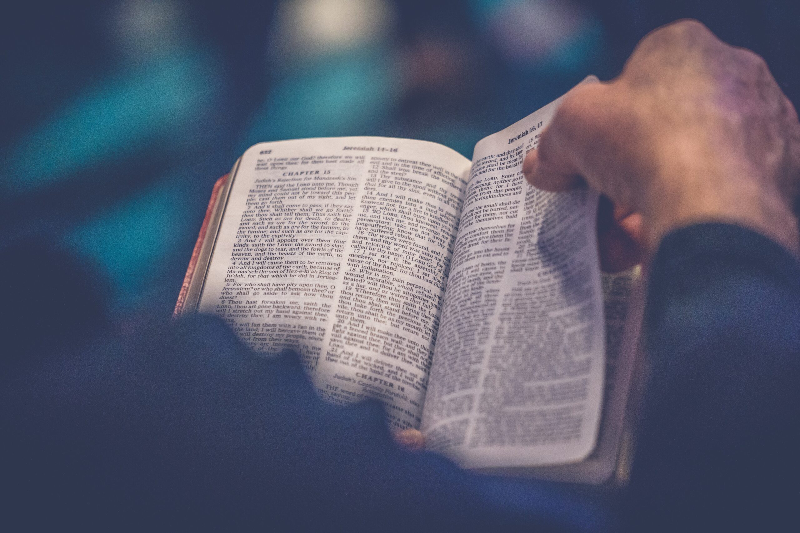 Person holding an open Bible